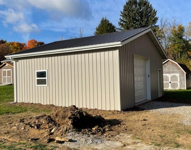New garage build with metal roofing and vertical siding