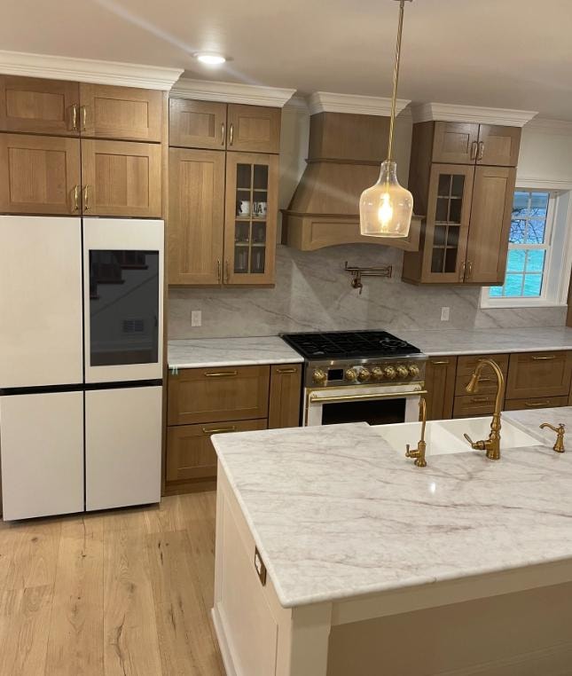Kitchen remodel with oak cabinets and marble countertops